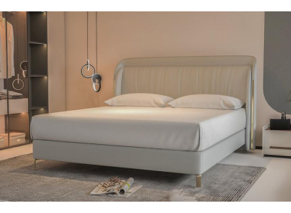Moderna cama de lujo en gris con un elegante cabecero dorado