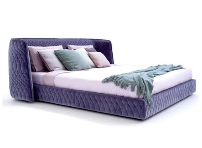 Moderna cama tapizada en lujoso terciopelo azul con un elegante cabecero