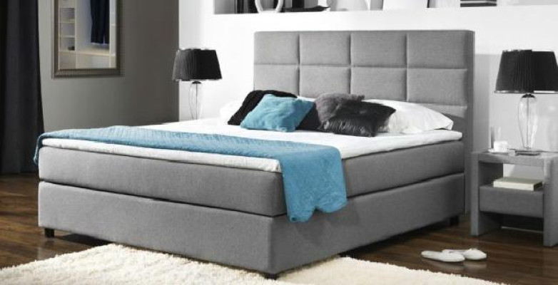 Cama boxspring continental para camas dobles en cuero acolchado alto.