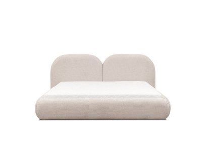 Dormitorio beige con cama doble con cabecero redondo de tela, camas tapizadas nuevas.