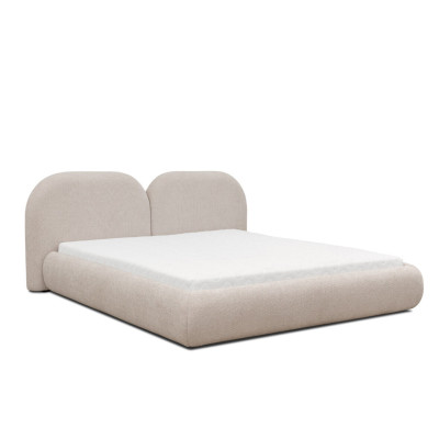 Dormitorio beige con cama doble con cabecero redondo de tela, camas tapizadas nuevas.