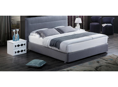 Cama de lujo con somier tapizado de tela azul del hotel. Muebles de dormitorio de diseño doble.