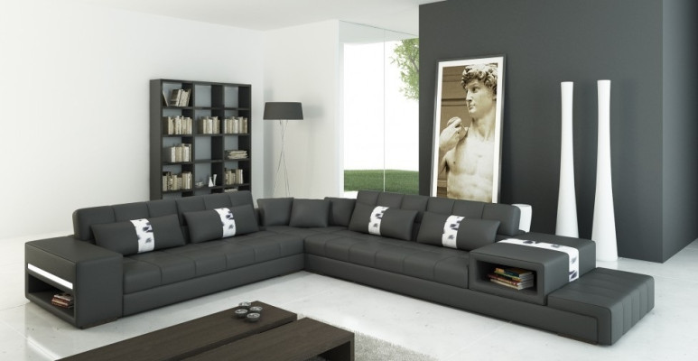 Moderna sensación de vivienda sofá esquinero en forma de L en gris oscuro con elegante tapizado de cuero sintético.