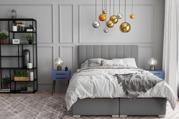 Cama Boxspring doble de hotel con diseño de caja tapizada y función de color gris.