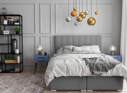 Cama Boxspring doble de hotel con diseño de caja tapizada y función de color gris.