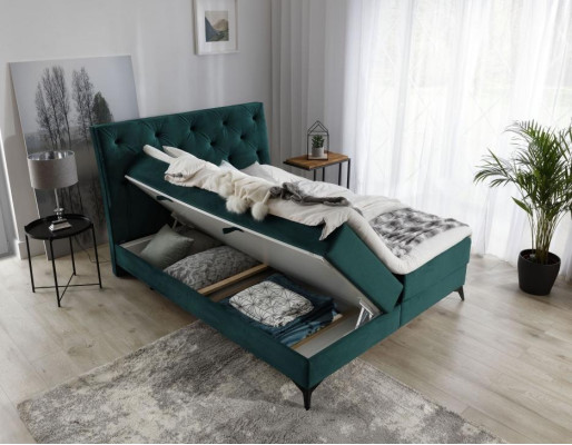 Cama boxspring de lujo de tela verde de hotel. Muebles de dormitorio de diseño en terciopelo nuevo.