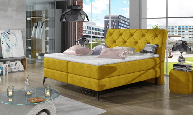 Cama boxspring de lujo de tela verde de hotel. Muebles de dormitorio de diseño en terciopelo nuevo.