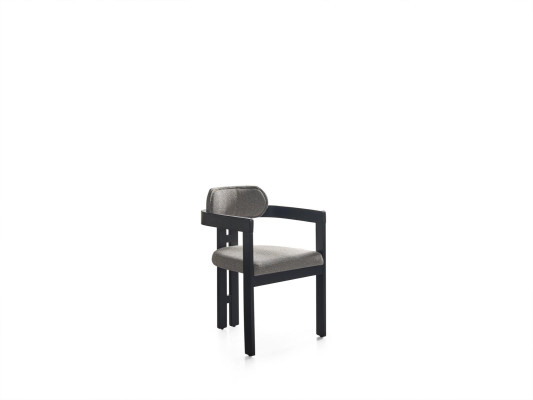 Una silla ultramoderna con una forma inusual e interesantes patas con un cómodo respaldo en gris y negro para el comedor.