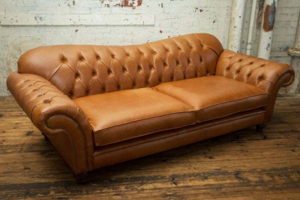 Sofá de lujo Chesterfield de tres plazas marrón para la sala de estar.