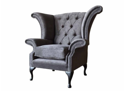Silla orejera modelo Chesterfield de tela de poliéster gris para sala de estar.