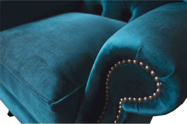 Sillón de orejas gris diseño tapizado Chesterfield textil salón