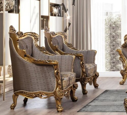 Una lujosa butaca clásica en gris oscuro con diseño barroco dorado de Chesterfield.
