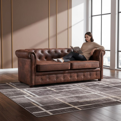 Sofá Chesterfield de lujo de cuero artificial para la sala de estar.