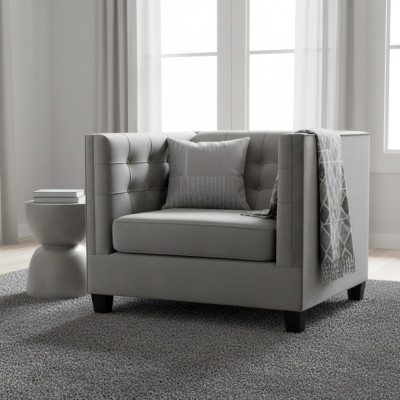 Sillón Chesterfield de tela gris nuevo de estilo moderno para la sala de estar.