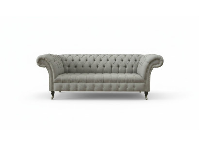 Sofá Chesterfield gris tapizado en tela de cuero y terciopelo.