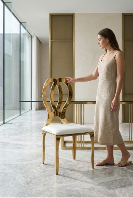 Silla de diseño de comedor con asiento tapizado de acero inoxidable sólido y tela.