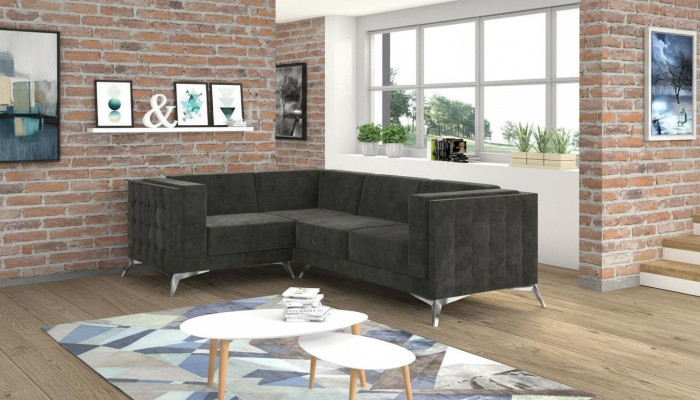 Sofá esquinero Chesterfield en forma de L de diseño de tela con asiento acolchado.