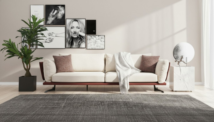 Sofá de cuatro plazas tapizado en tela de color beige con diseño moderno de lujo para la sala de estar.