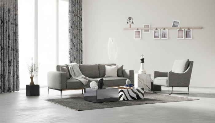 Sofá de 4 plazas con butaca de tela en diseño moderno de color gris.