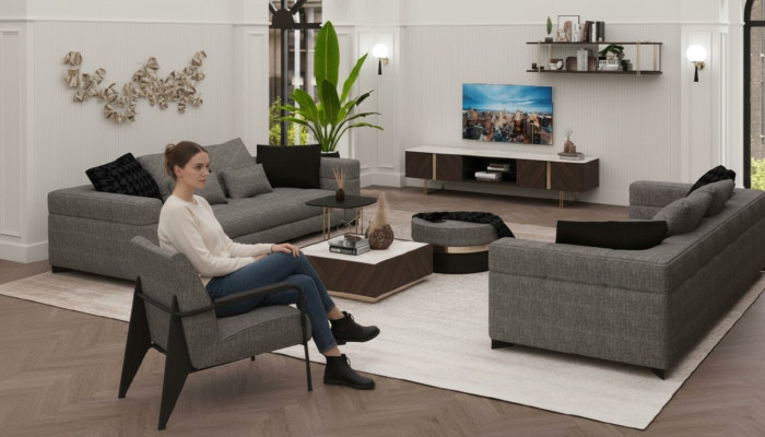 Sillón gris con patas de acero inoxidable. Muebles de salón modernos. Sillón sofá.
