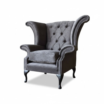 Silla orejera modelo Chesterfield de tela de poliéster gris para sala de estar.
