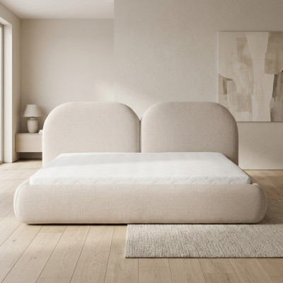 Dormitorio beige con cama doble con cabecero redondo de tela, camas tapizadas nuevas.