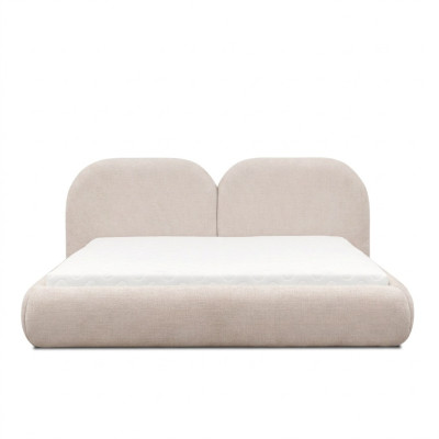 Dormitorio beige con cama doble con cabecero redondo de tela, camas tapizadas nuevas.