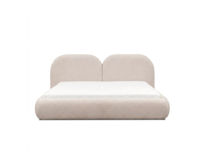 Dormitorio beige con cama doble con cabecero redondo de tela, camas tapizadas nuevas.