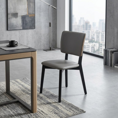 Silla de comedor gris de diseñador de una plaza tapizada de cuero.