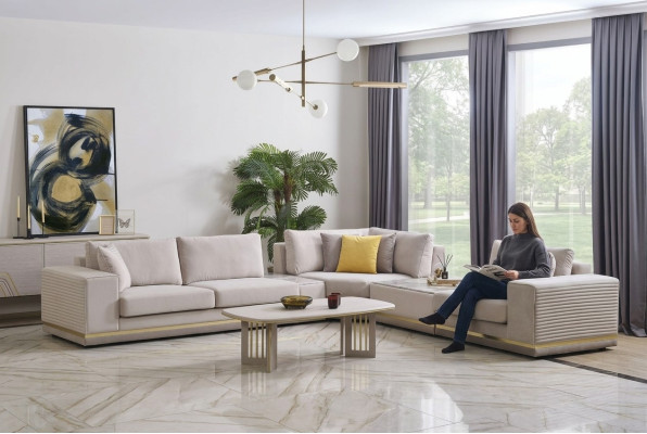 Sofá esquinero moderno en forma de L de textil color beige claro para sala de estar.