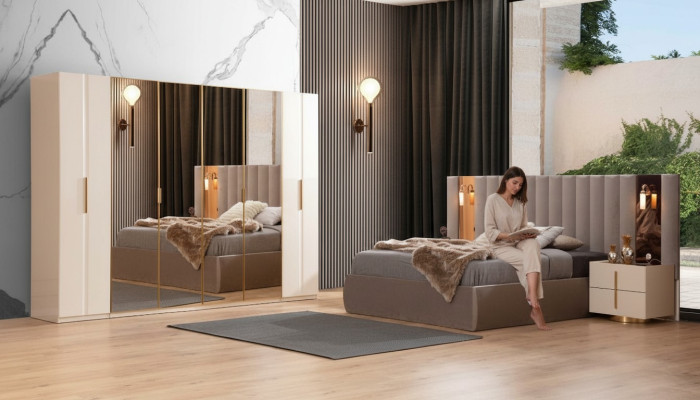 Juego de dormitorio beige con cama de diseñador, armario, y 2 mesitas de noche.
