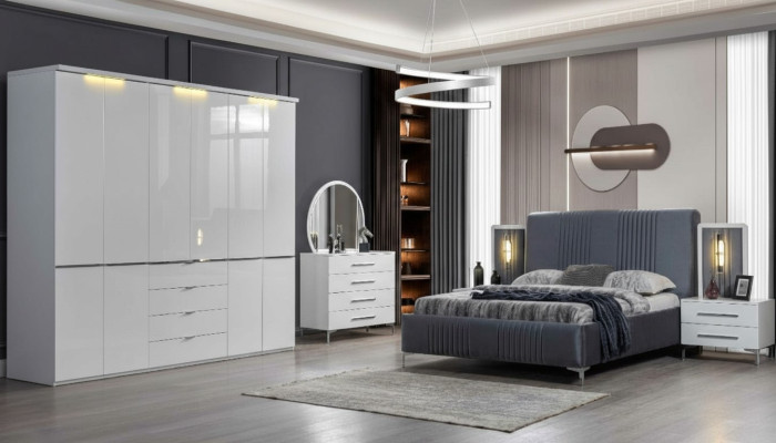 Muebles de dormitorio blancos. Cama textil. Armario grande. Mesitas de noche.