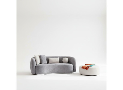 Moderno sofá gris de diseño moderno de cuatro plazas con sofá tapizado y reposapiés nuevos.