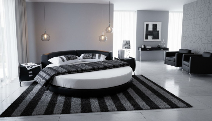 Moderna cama negra con detalles elegantes y un sofá