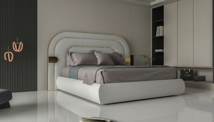 Cama gris lujosa con acentos dorados en diseño moderno y cabecera acolchada