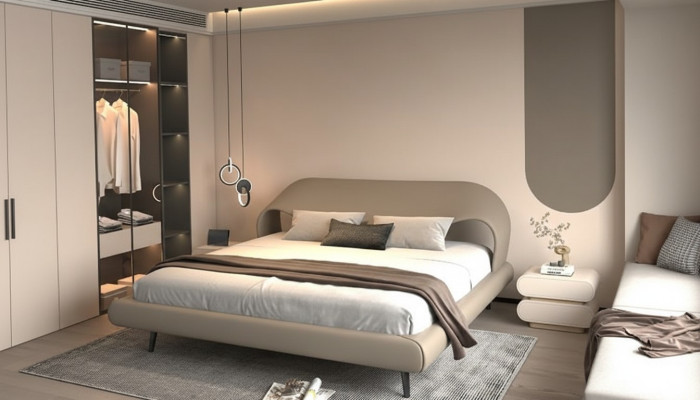 Cama gris elegante con diseño minimalista y redondeado