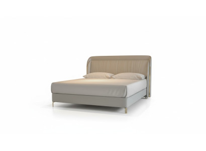 Moderna cama de lujo en gris con un elegante cabecero dorado