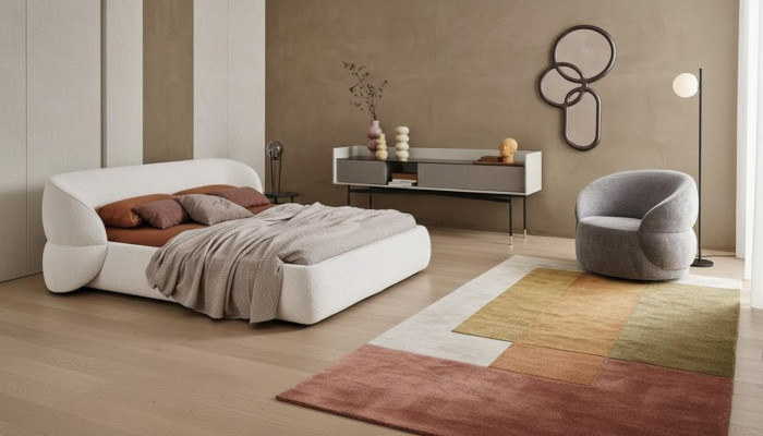 Moderno sofá tapizado con función de cama en elegante tela gris