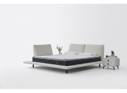 Cama boxspring moderna con cabecero blanco minimalista