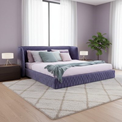 Moderna cama tapizada en lujoso terciopelo azul con un elegante cabecero